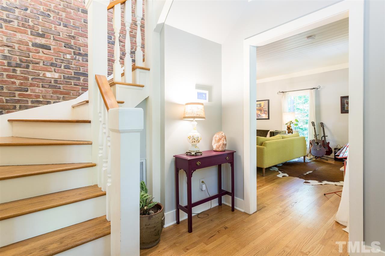 11809 Appaloosa Run East Raleigh, NC 27613 - Photo 5 of 30 You are greeted in this lovely entry foyer by a stunning wall of brick and gorgeous hardwood flooring. The foyer is painted in a tasteful and relaxing color to provide the ultimate welcoming experience to your lovely new home.
