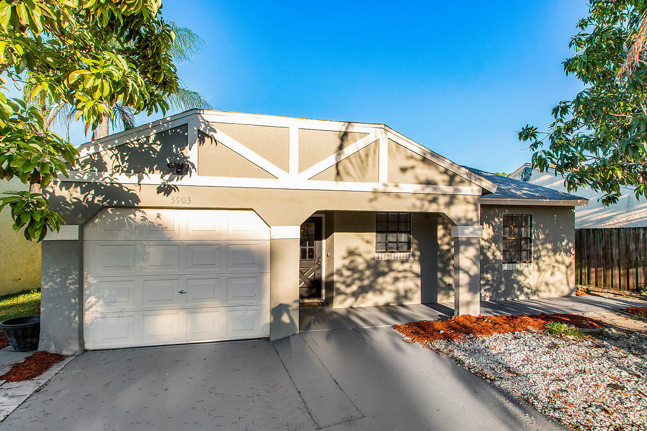 5903 Southeast Mitzi Lane Stuart, FL 34997 - Photo 2 of 22 a view of a balcony with a tree