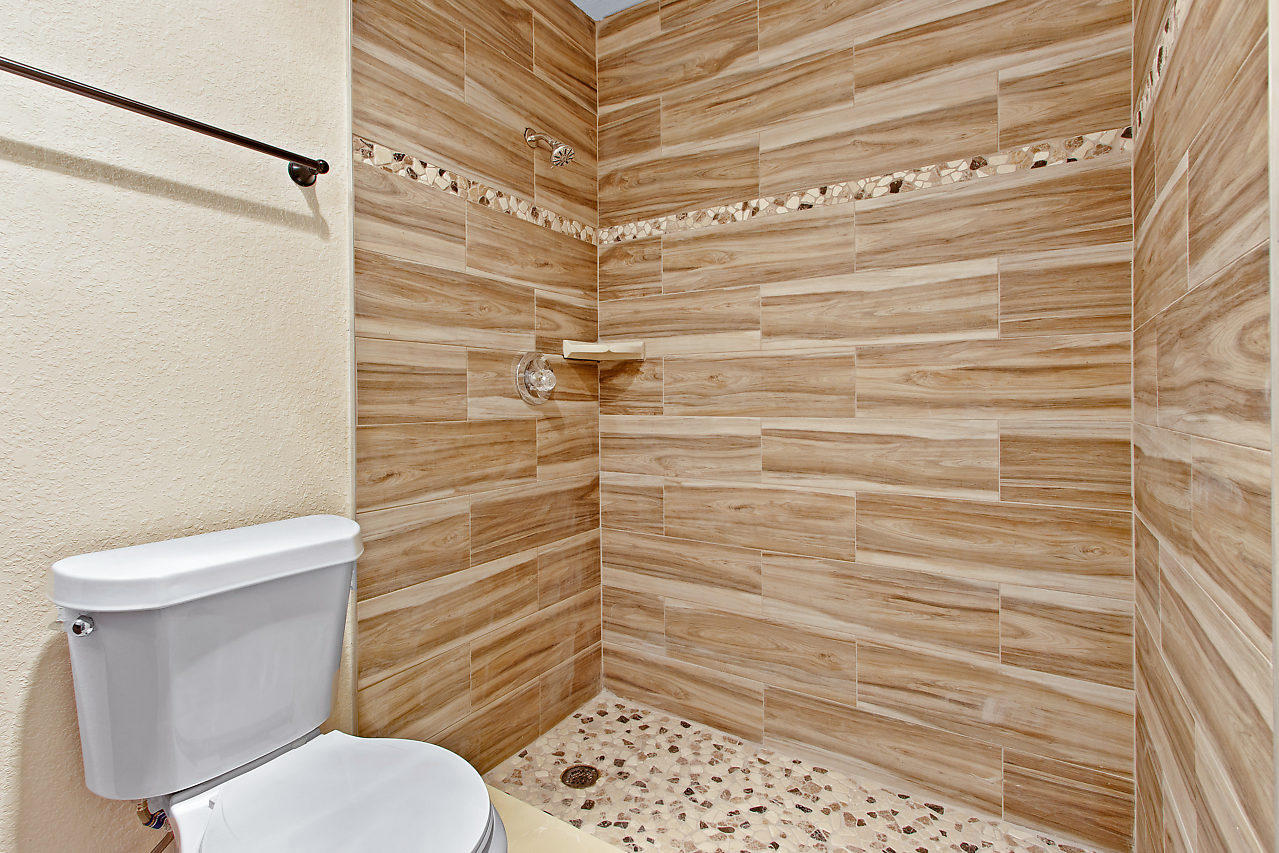 5903 Southeast Mitzi Lane Stuart, FL 34997 - Photo 14 of 22 a bathroom with a toilet and a shower