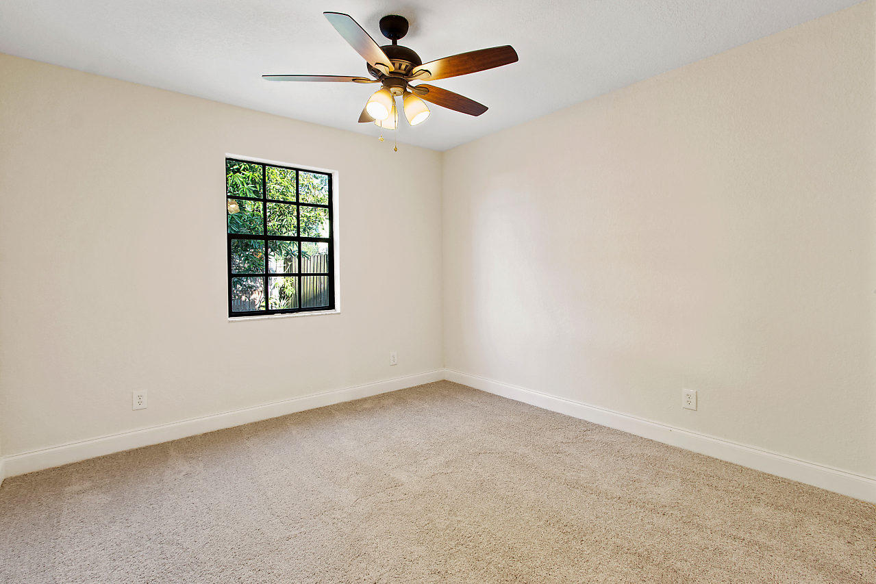 5903 Southeast Mitzi Lane Stuart, FL 34997 - Photo 15 of 22 an empty room with a window and a fan