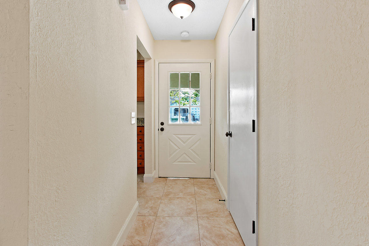 5903 Southeast Mitzi Lane Stuart, FL 34997 - Photo 3 of 22 an entryway to room with wooden floor
