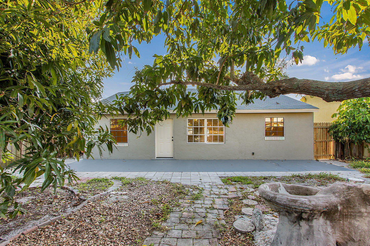 5903 Southeast Mitzi Lane Stuart, FL 34997 - Photo 22 of 22 a view of a house with a yard