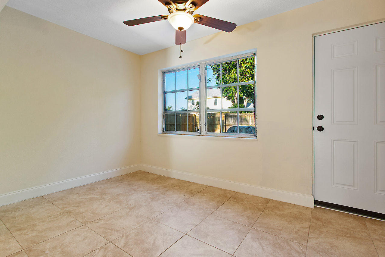 5903 Southeast Mitzi Lane Stuart, FL 34997 - Photo 10 of 22 an empty room with fan and windows