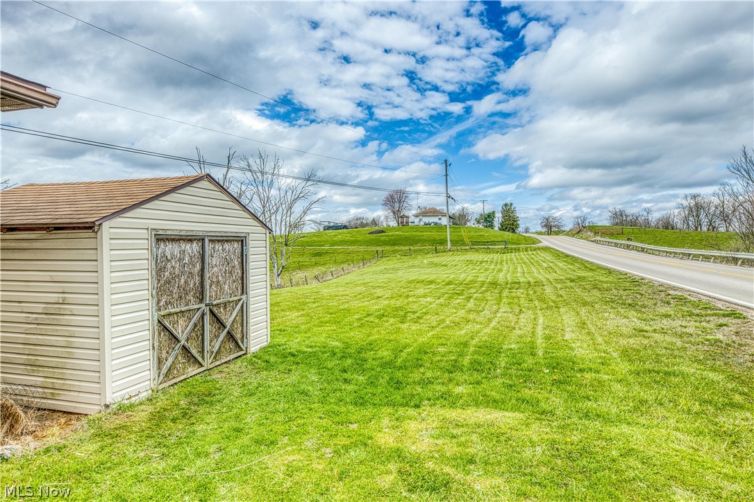 7848 Clay Pike Road Cambridge, OH 43725 - Photo 4 of 12 View of yard featuring a storage unit