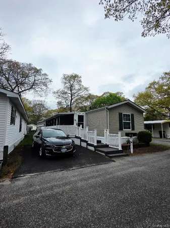 a couple of cars parked in front of a house
