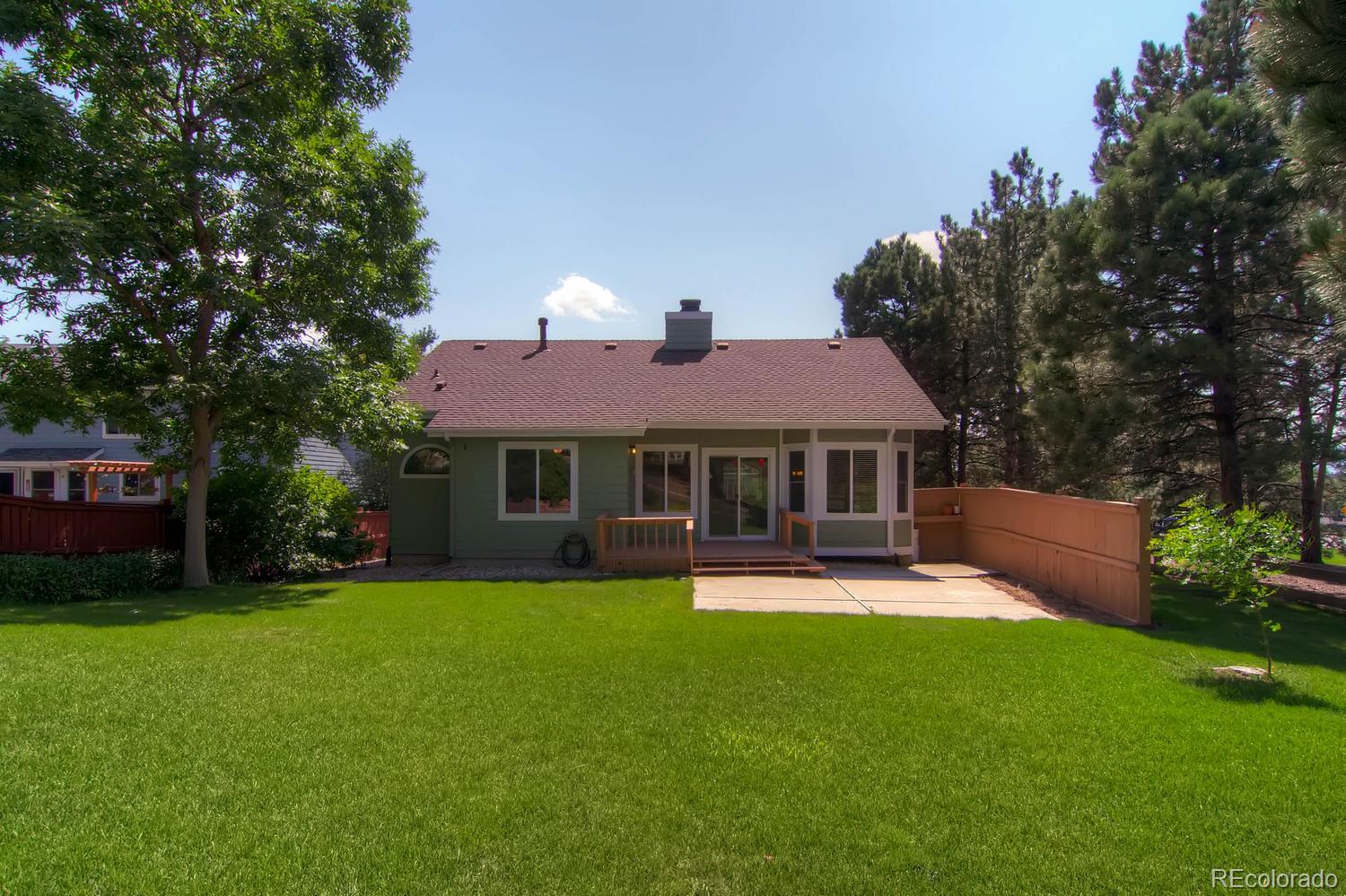 3 Jack Rabbit Place Highlands Ranch, CO 80126 - Photo 28 of 28 a front view of a house with a yard porch and sitting area
