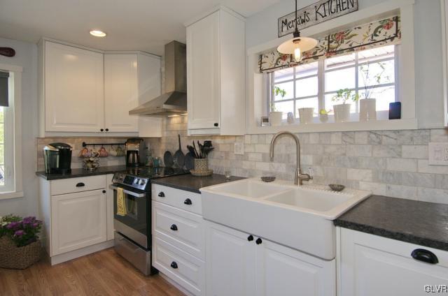 Kitchen window overlooks deck and outdoor entertai