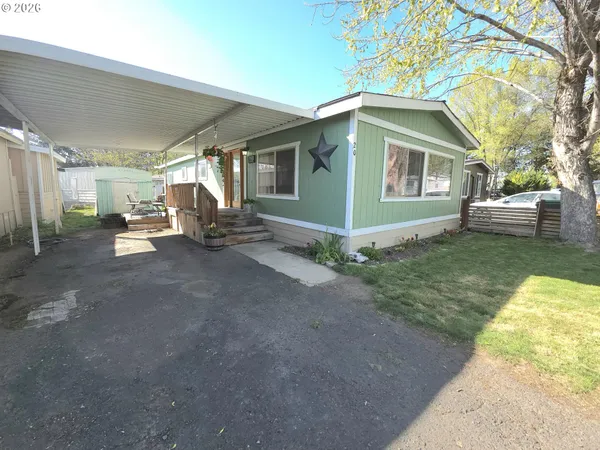 a view of a house with a yard and pathway