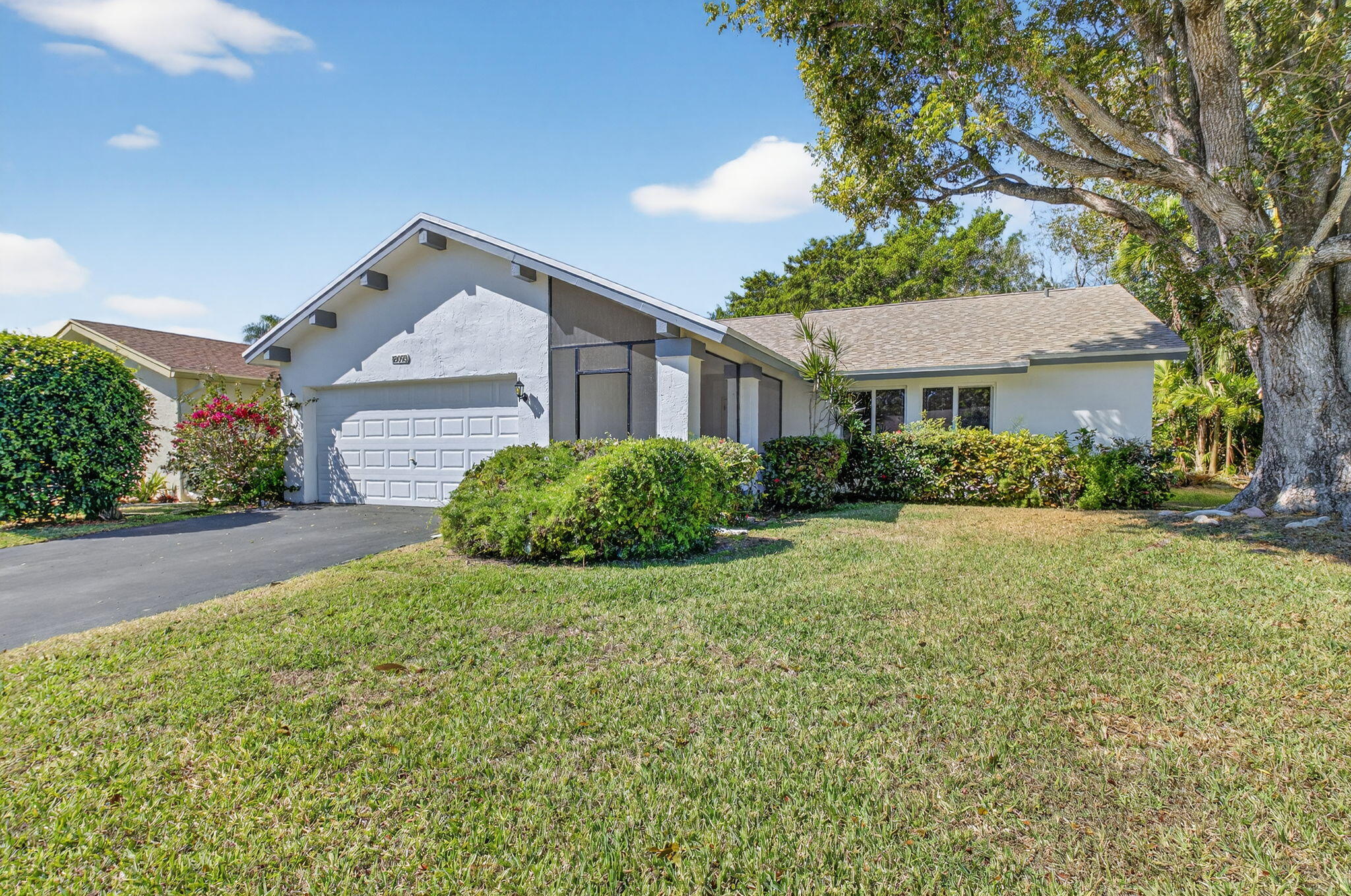 18093 104th Terrace South Boca Raton, FL 33498 - Photo 25 of 43 a view of a house with a big yard and large trees
