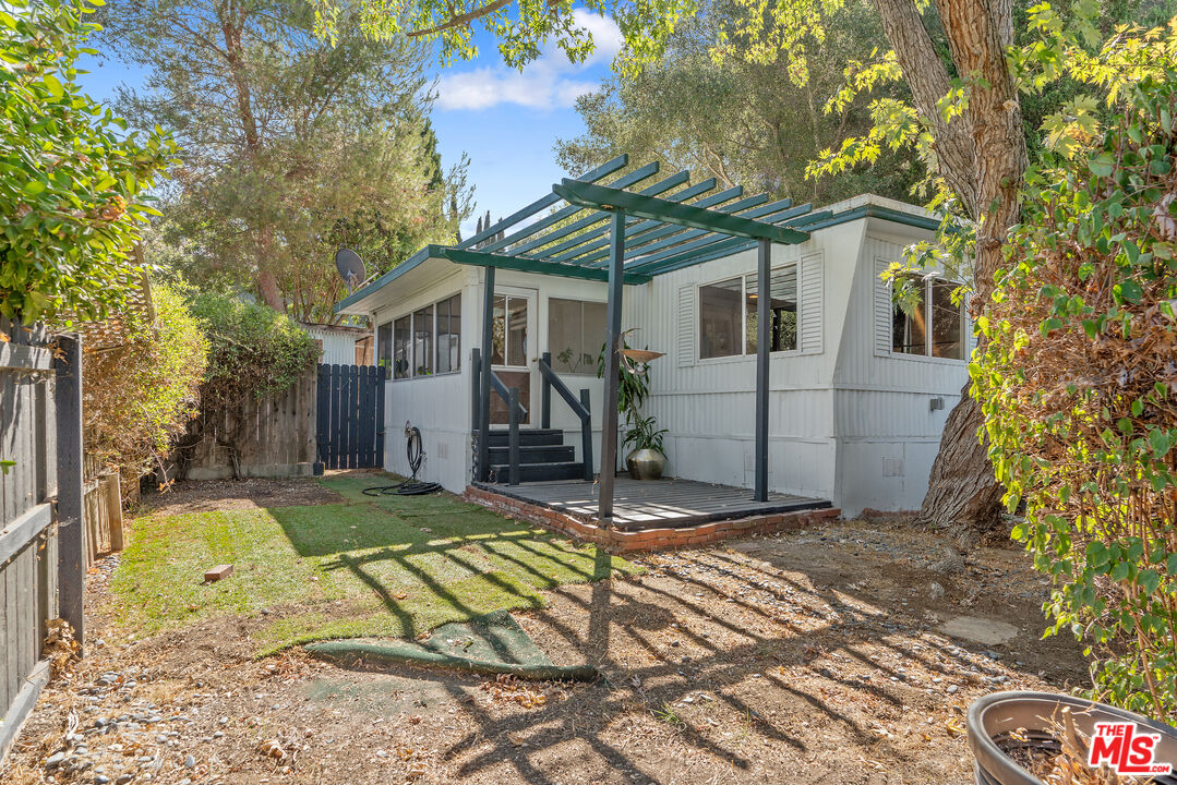 1667 Las Virgenes Canyon Road, Unit 9 Calabasas, CA 91302 - Photo 14 of 29 a view of a house with a yard