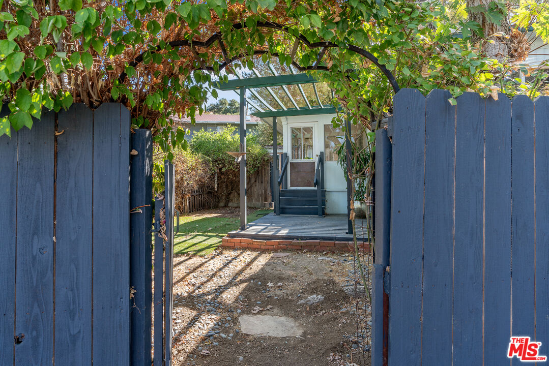 1667 Las Virgenes Canyon Road, Unit 9 Calabasas, CA 91302 - Photo 16 of 29 a view of a entrance gate of the house and trees