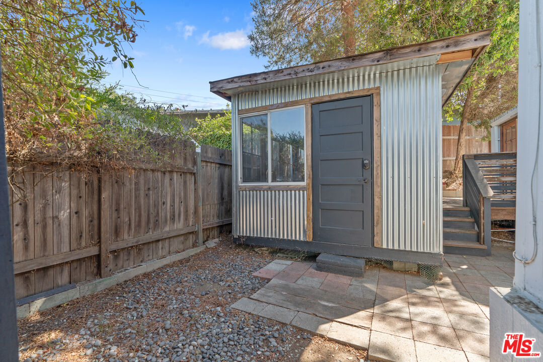 1667 Las Virgenes Canyon Road, Unit 9 Calabasas, CA 91302 - Photo 21 of 29 a view of a house with wooden fence