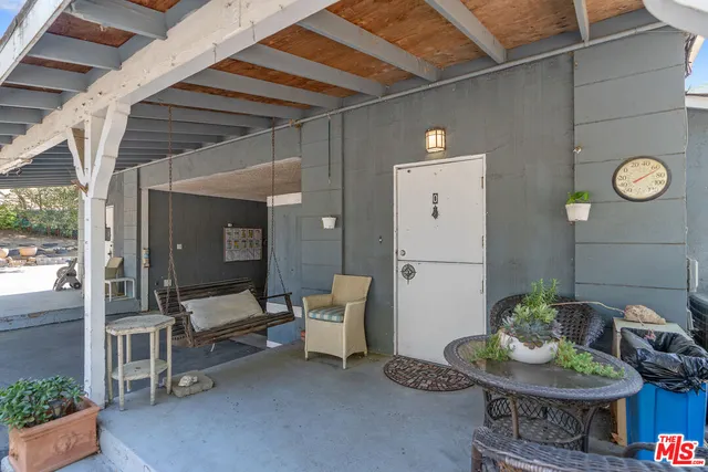 a view of a house with backyard and a tree
