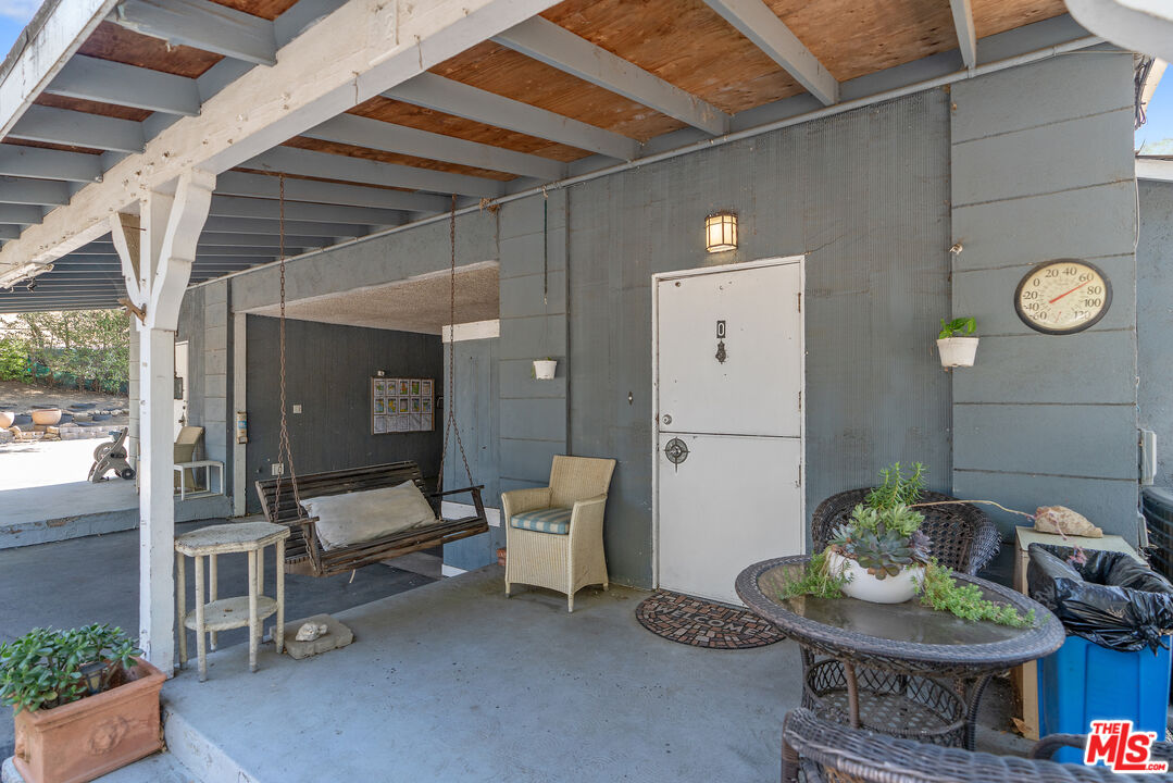 1667 Las Virgenes Canyon Road, Unit 9 Calabasas, CA 91302 - Photo 26 of 29 a living room with furniture and a table