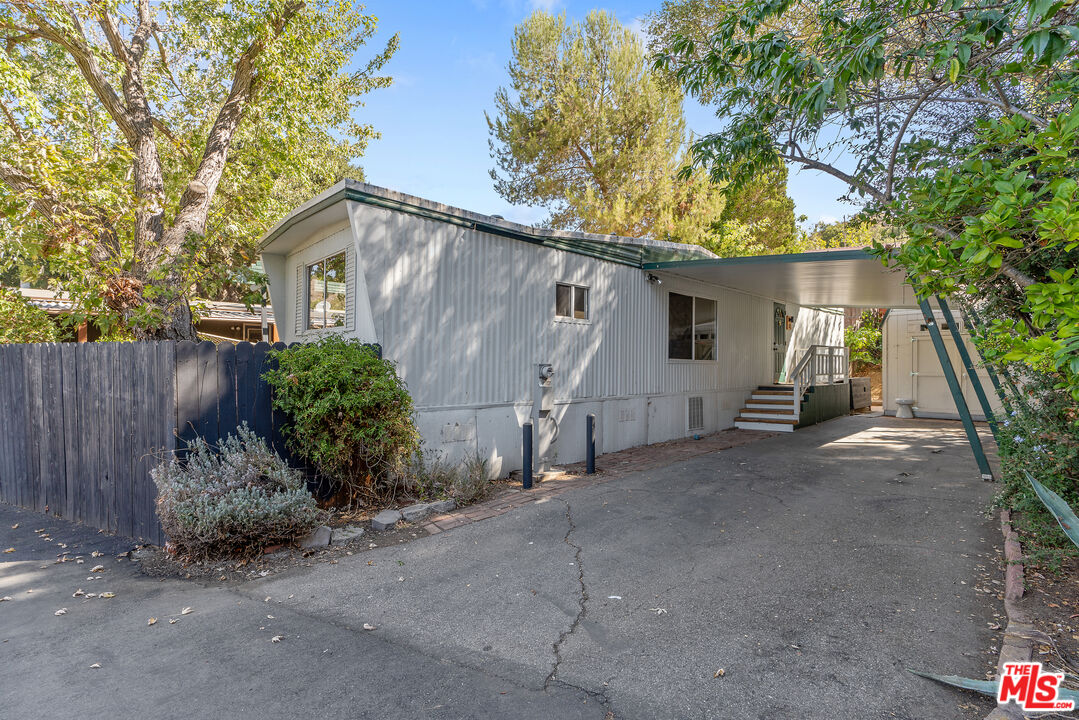 1667 Las Virgenes Canyon Road, Unit 9 Calabasas, CA 91302 - Photo 27 of 29 a view of a house with backyard and a tree