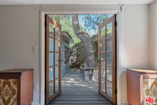 a view of a hallway with wooden floor and a floor to ceiling window