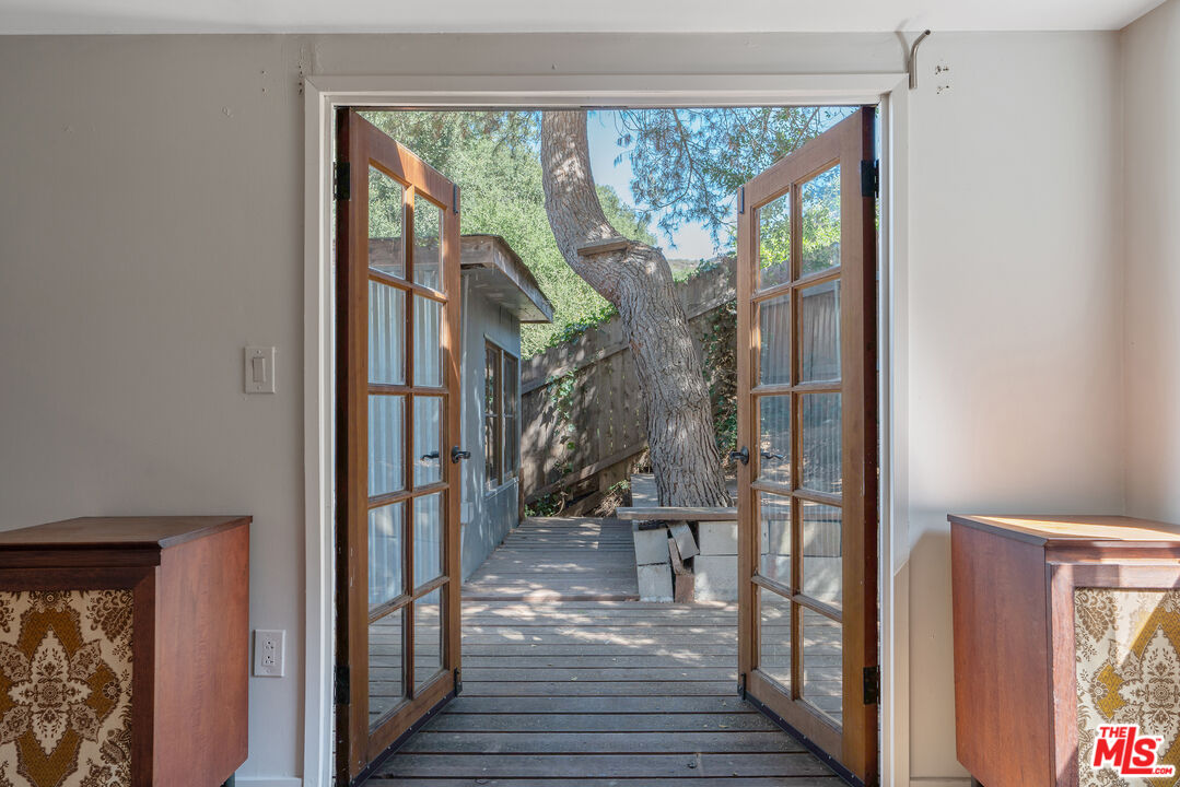 1667 Las Virgenes Canyon Road, Unit 9 Calabasas, CA 91302 - Photo 10 of 29 a view of a hallway with wooden floor and a floor to ceiling window
