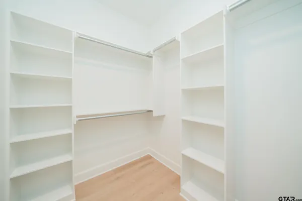 a bathroom with a double vanity sink and mirror with bathtub