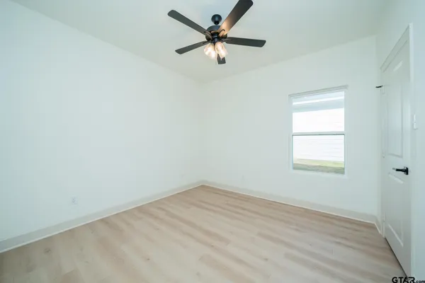 a view of a kitchen with a sink and a refrigerator