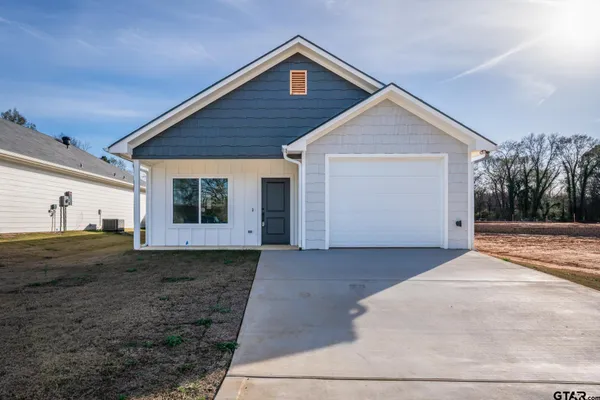 a kitchen with granite countertop a sink window and cabinets