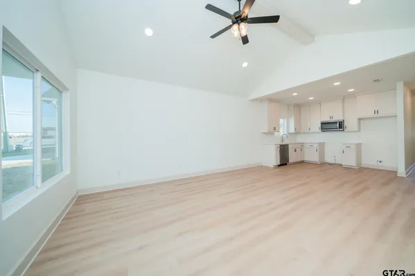 a kitchen with cabinets appliances a sink and a window