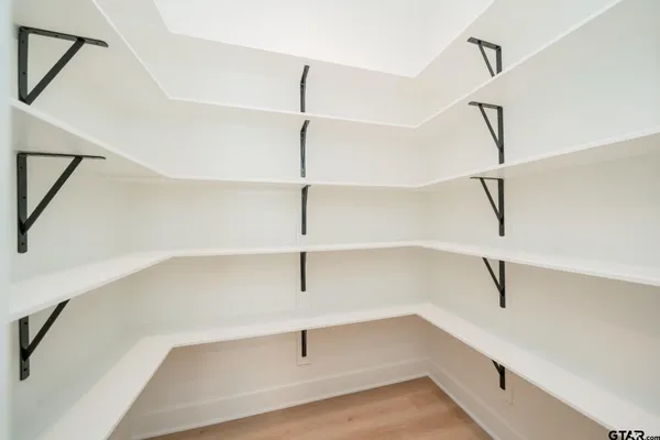 a spacious bathroom with a double vanity sink and mirror