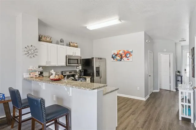 a bedroom with a bed and a night stand