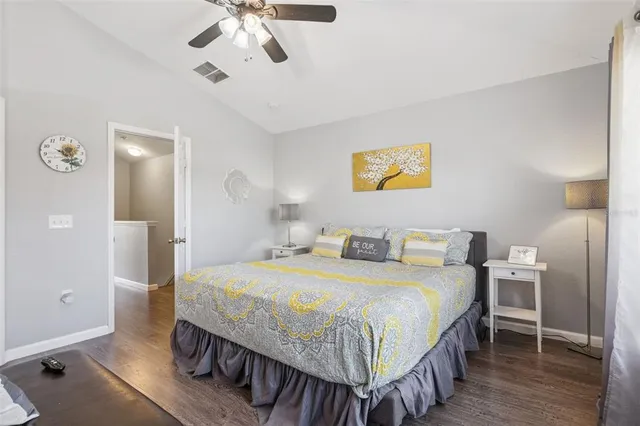 a bedroom with a bed and a flat tv screen on dresser