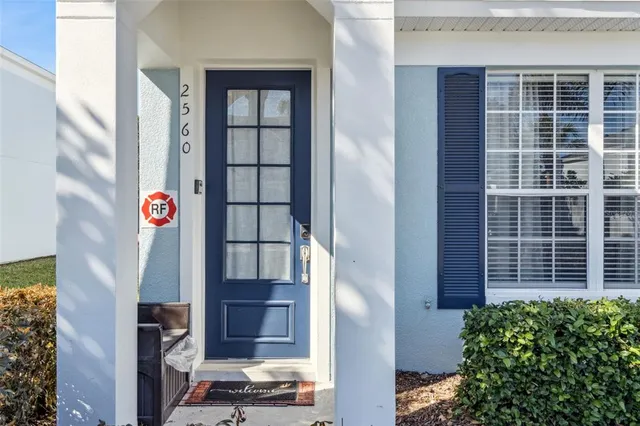 a view of hallway with livingroom and wooden floor