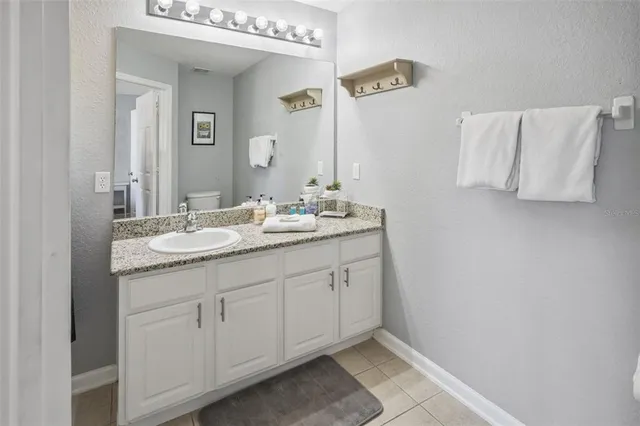 a view of a house with a yard and a tree