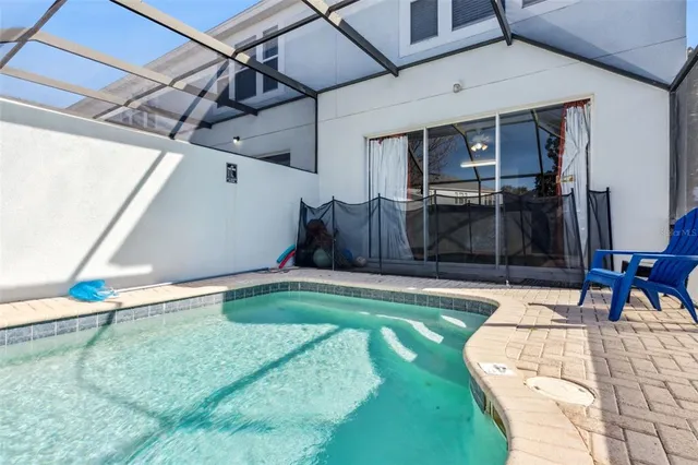 an aerial view of a swimming pool with a yard