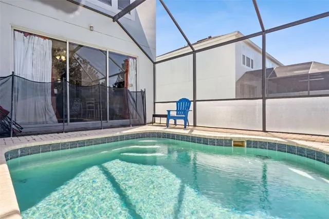 an aerial view of residential houses with outdoor space and swimming pool