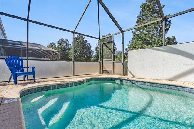 an aerial view of residential house with outdoor space and swimming pool