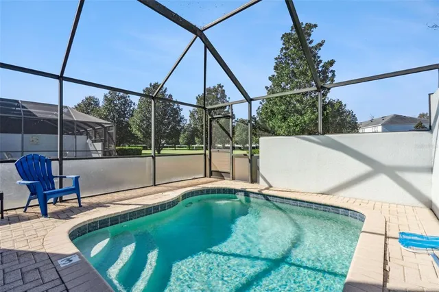 an aerial view of residential houses with outdoor space and swimming pool