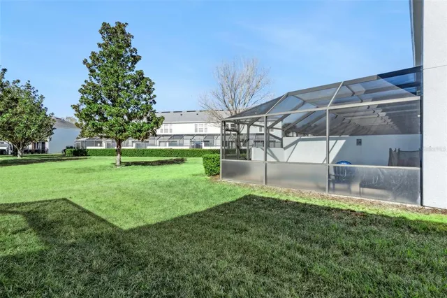 a living room with patio furniture and a large window