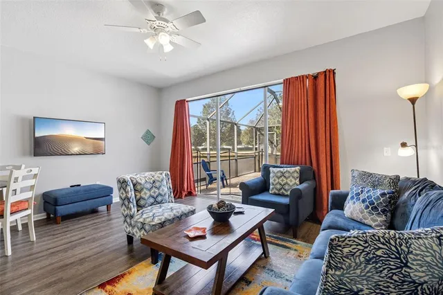 a living room with furniture and wooden floor