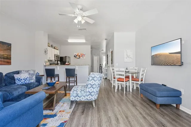 a kitchen with stainless steel appliances granite countertop a sink and cabinets with wooden floor