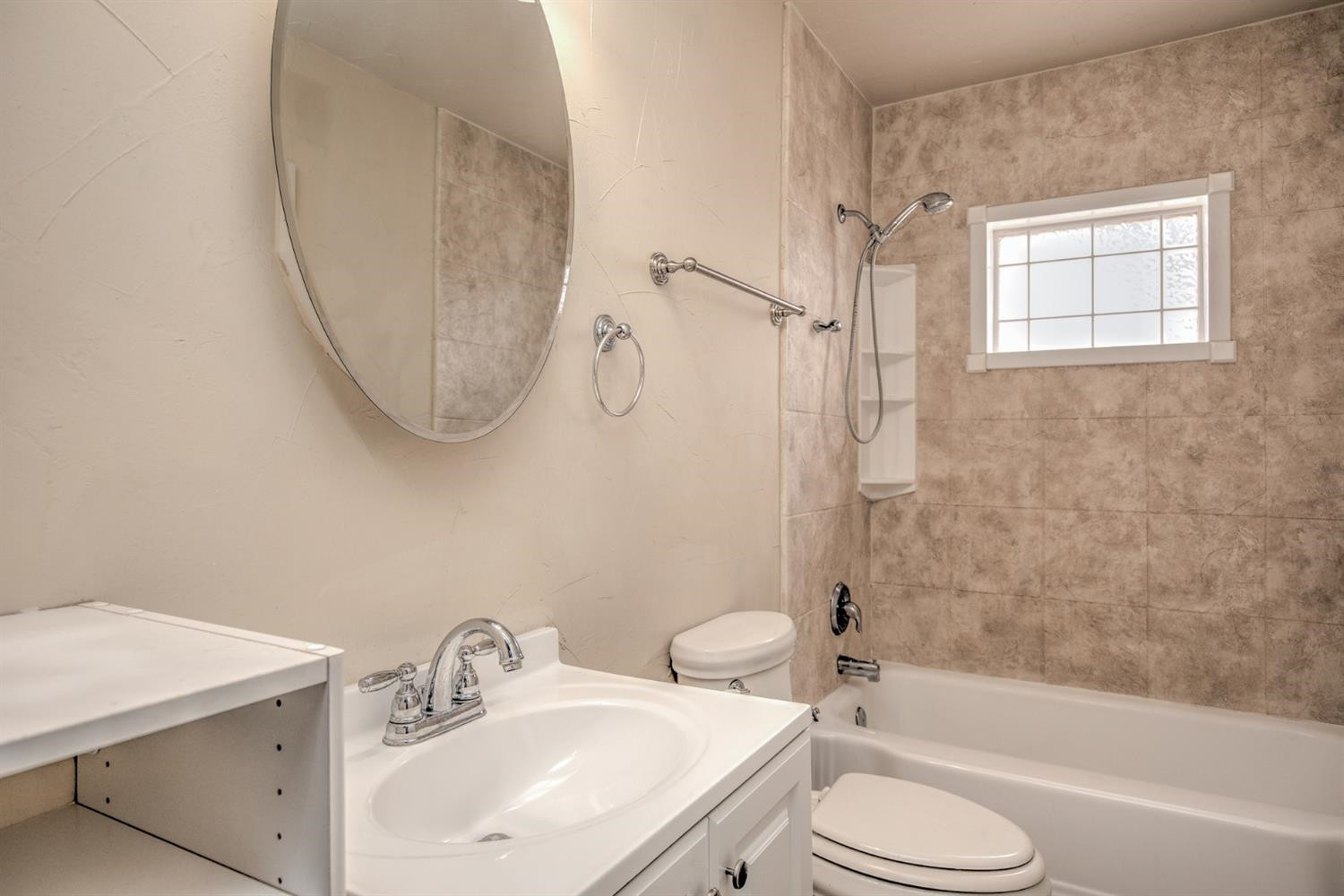 3008 30th Street Lubbock, TX 79410 - Photo 15 of 29 a bathroom with a sink toilet and shower