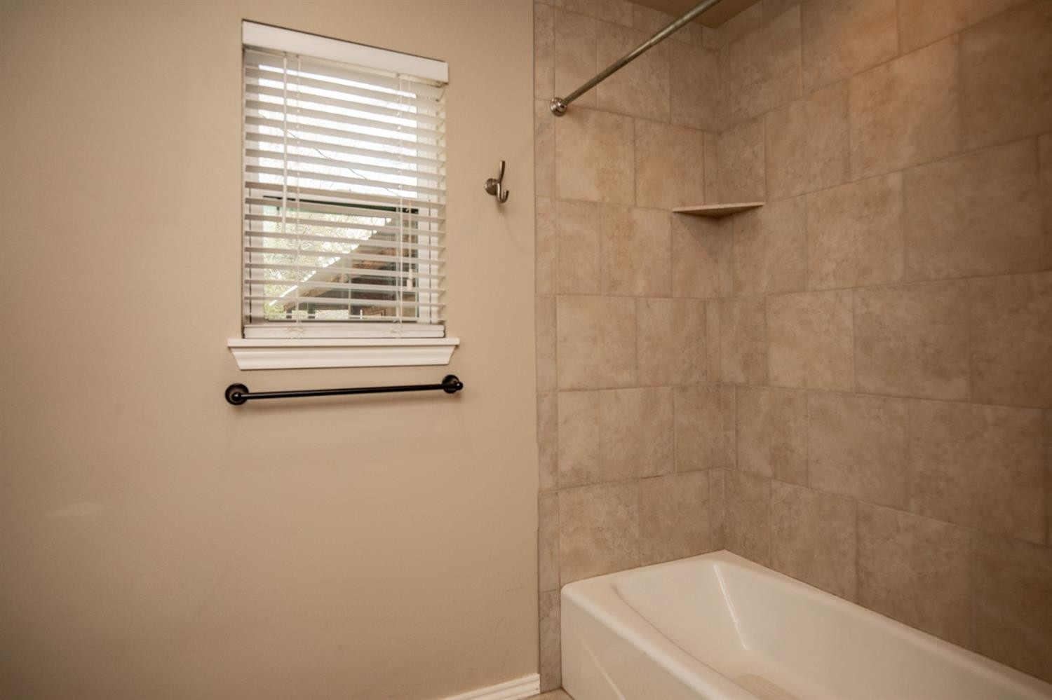 3008 30th Street Lubbock, TX 79410 - Photo 21 of 29 a bathroom with a white bath tub and a window