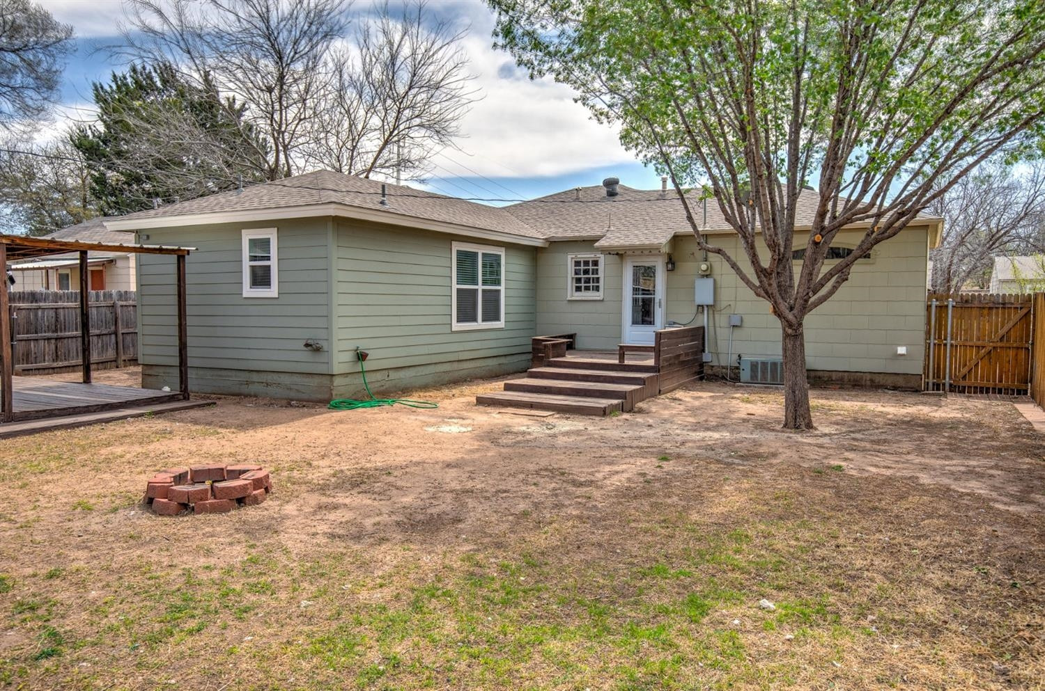 3008 30th Street Lubbock, TX 79410 - Photo 22 of 29 a backyard of a house with yard and trees