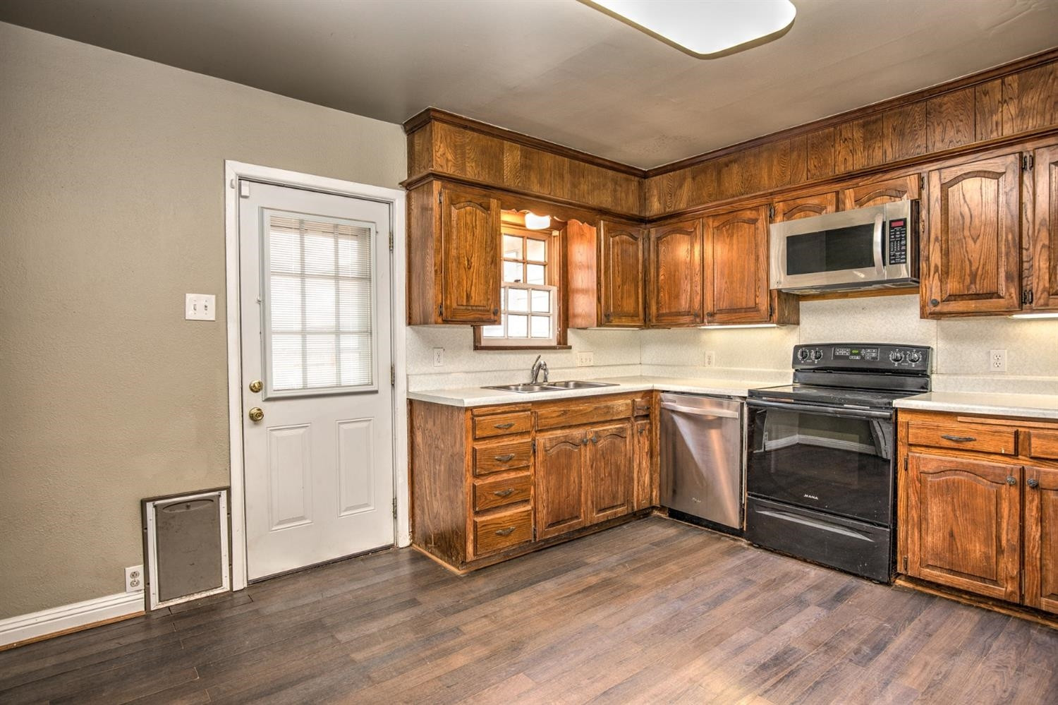 3008 30th Street Lubbock, TX 79410 - Photo 6 of 29 a kitchen with stainless steel appliances granite countertop a stove a sink and a microwave
