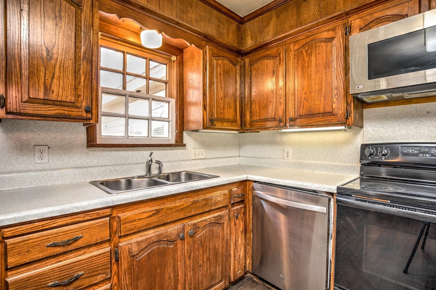 3008 30th Street Lubbock, TX 79410 - Photo 8 of 29 a kitchen with stainless steel appliances granite countertop a sink and a microwave