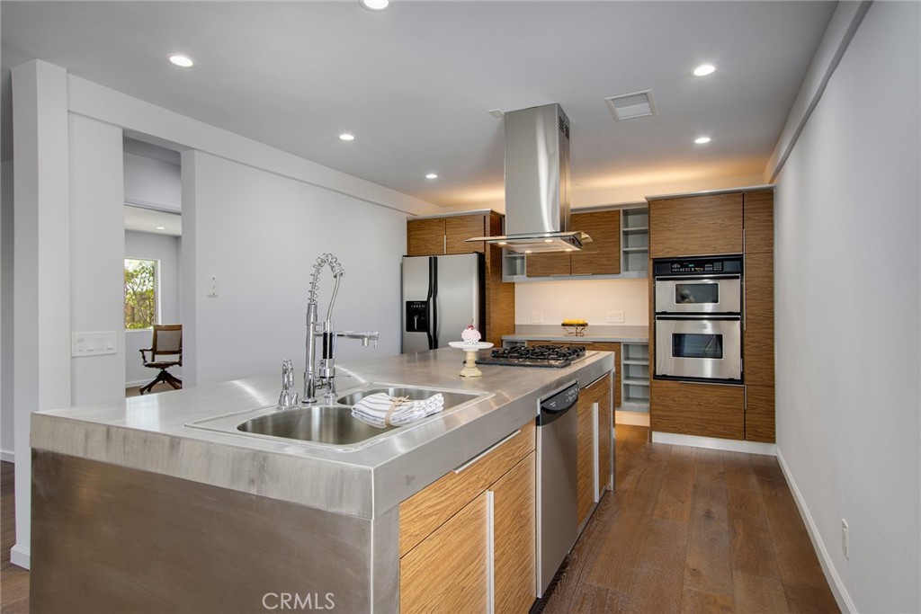 7320 Sherwood Road Joshua Tree, CA 92252 - Photo 15 of 44 a kitchen with stainless steel appliances granite countertop a sink and a refrigerator