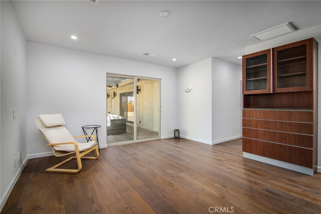 7320 Sherwood Road Joshua Tree, CA 92252 - Photo 25 of 44 a view of an empty room with wooden floor and furniture