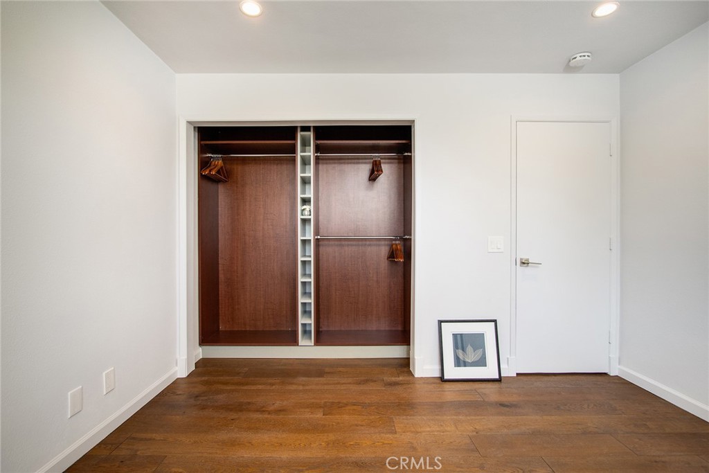 7320 Sherwood Road Joshua Tree, CA 92252 - Photo 30 of 44 an empty room with wooden floor and closet
