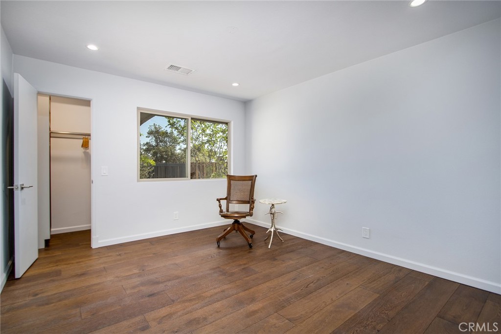 7320 Sherwood Road Joshua Tree, CA 92252 - Photo 32 of 44 a view of a room with wooden floor lounge chair and windows