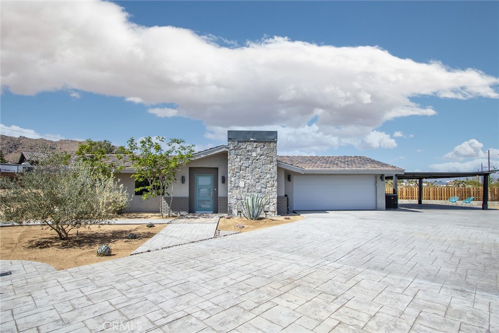 7320 Sherwood Road Joshua Tree, CA 92252 - Photo 7 of 44 a view of a white house with a patio