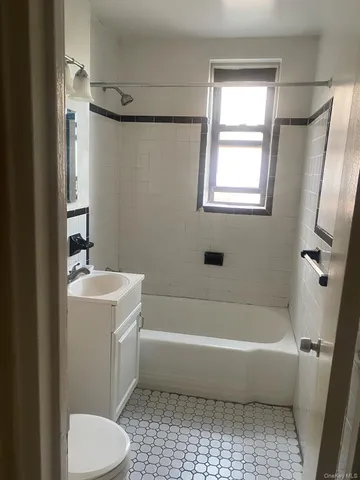 a white bath tub sitting next to a white toilet