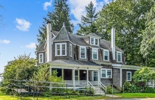 a front view of a residential apartment building with a yard