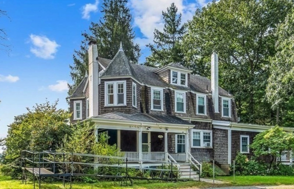 a front view of a residential apartment building with a yard